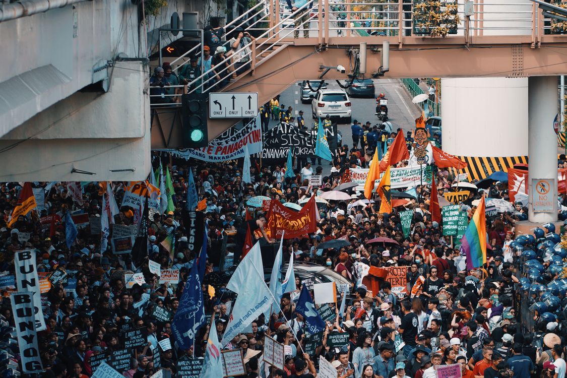 Crowded Street Protest with Colorful Banners · Free Stock Photo