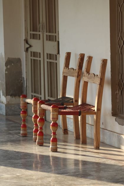 Two rustic wooden chairs in a sunlit corridor — photo by Dr Photographer on Pexels
