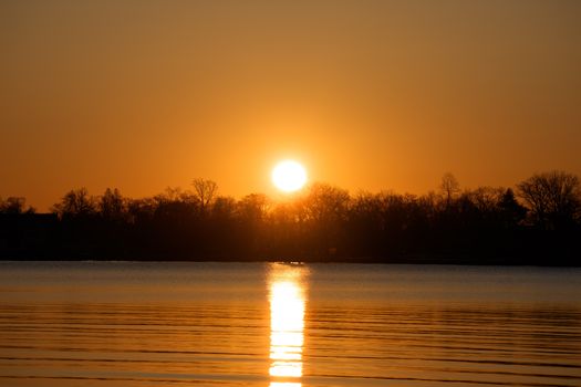 Beautiful winter sunrise over Cove Island Park in Stamford, Connecticut, capturing the tranquil scene with a warm glow.