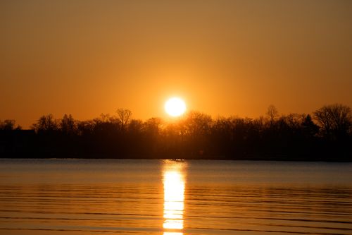 Free Beautiful winter sunrise over Cove Island Park in Stamford, Connecticut, capturing the tranquil scene with a warm glow. Stock Photo