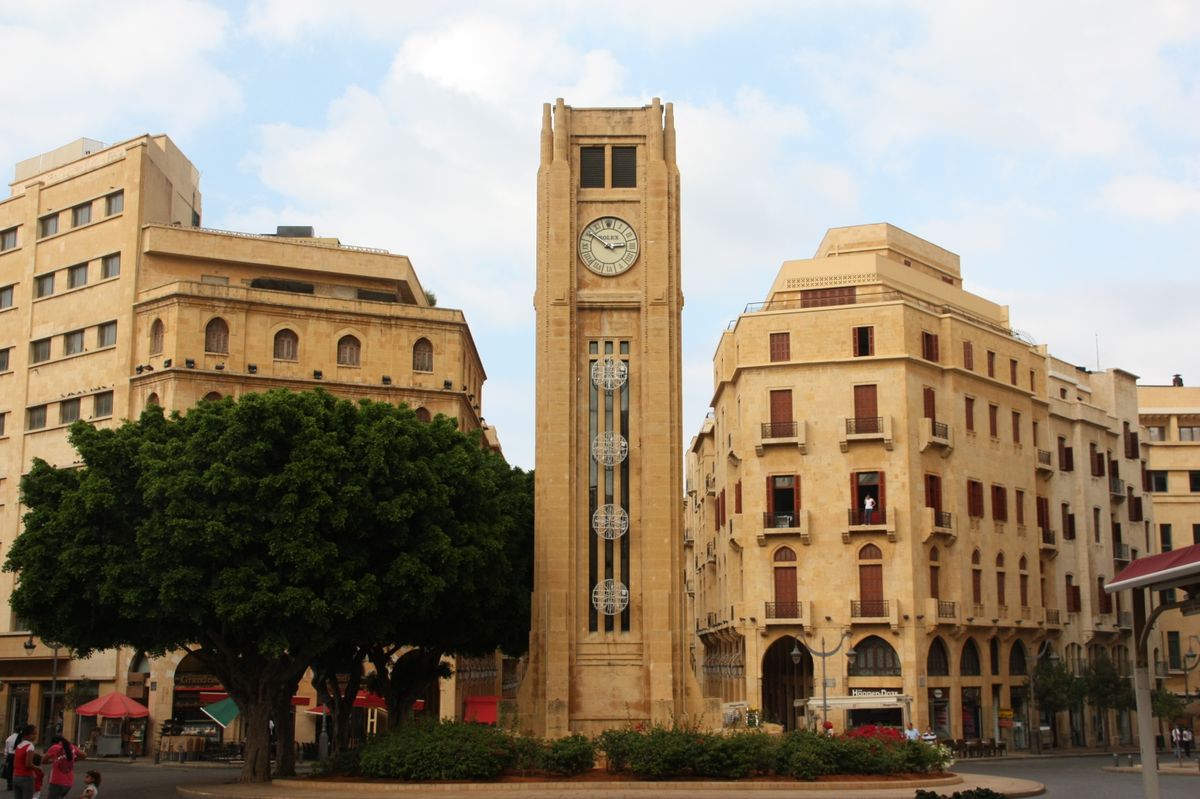 The Nejmeh Square clock tower in downtown Beirut, framed by sandstone Ottoman- and French Mandate-era buildings.