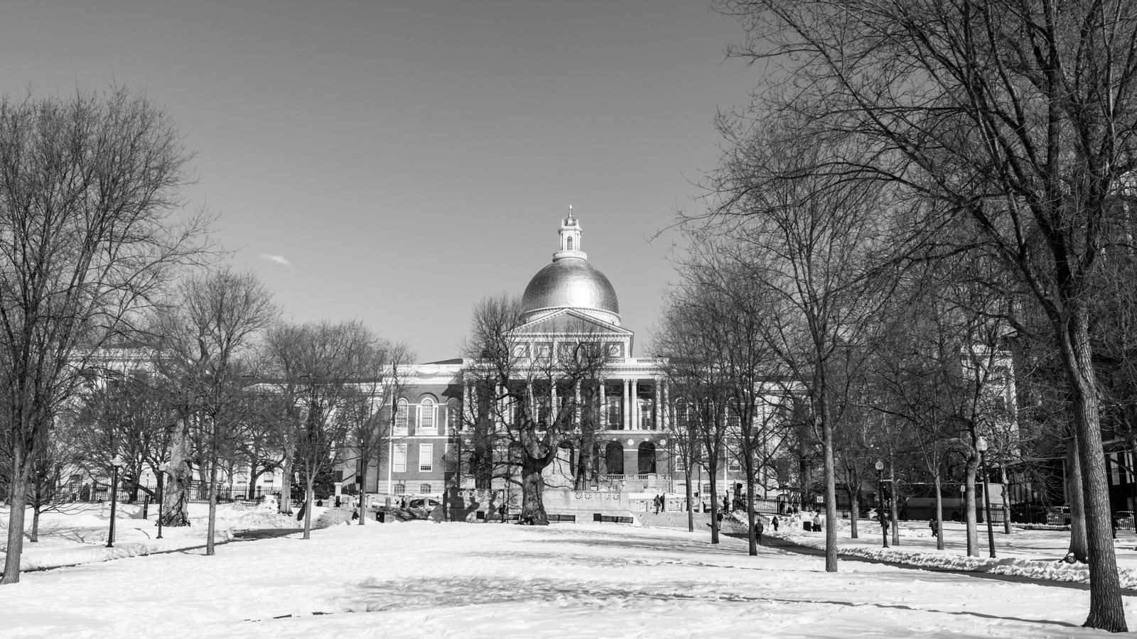 Black and white photo of the Massachusetts State House during winter in Boston.