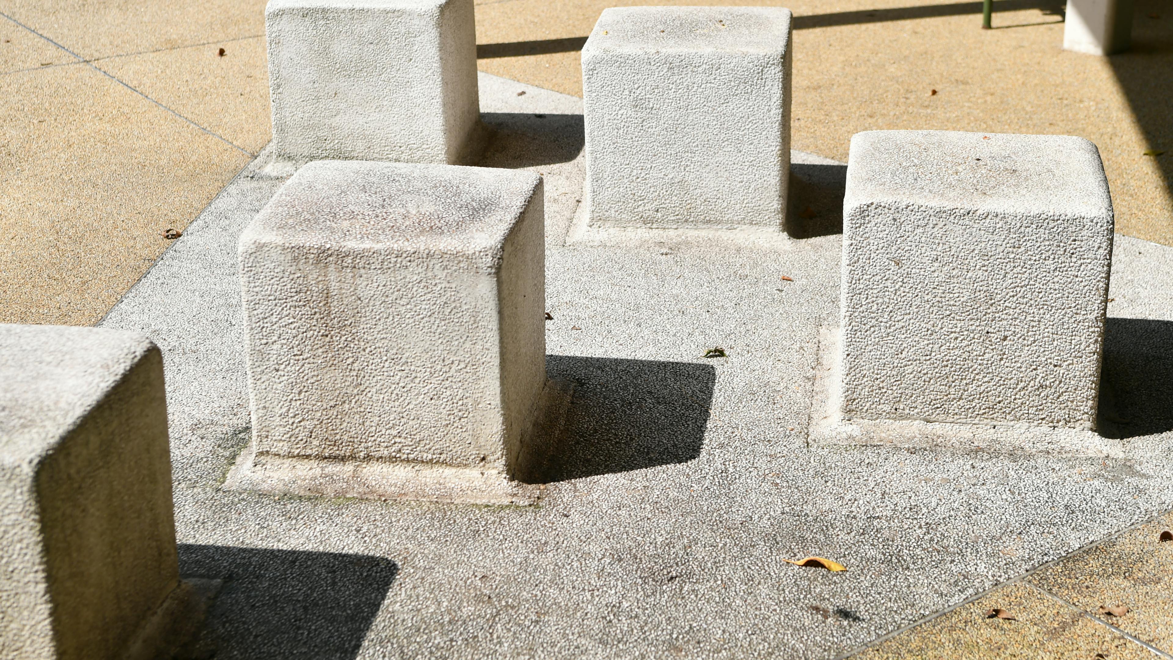 Free A group of abstract concrete blocks casting shadows on a sunny day. Stock Photo