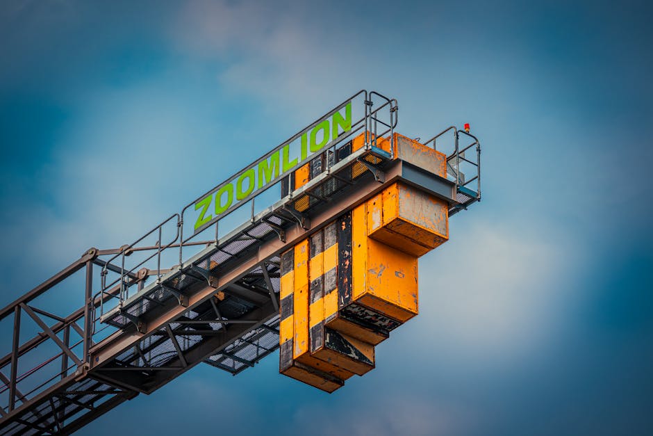Close-up of a Zoomlion construction crane with a blue sky backdrop, highlighting industrial architecture.