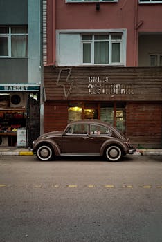 Classic brown car parked outside grill restaurant in urban setting. Retro vibes.