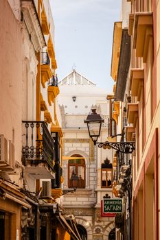 Colorful buildings line a picturesque street in Ayamonte, Spain, capturing Andalusian charm.