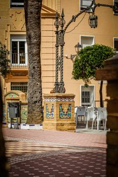 Sunny plaza in Ayamonte, Spain featuring a classic Spanish fountain and tiled decorations.