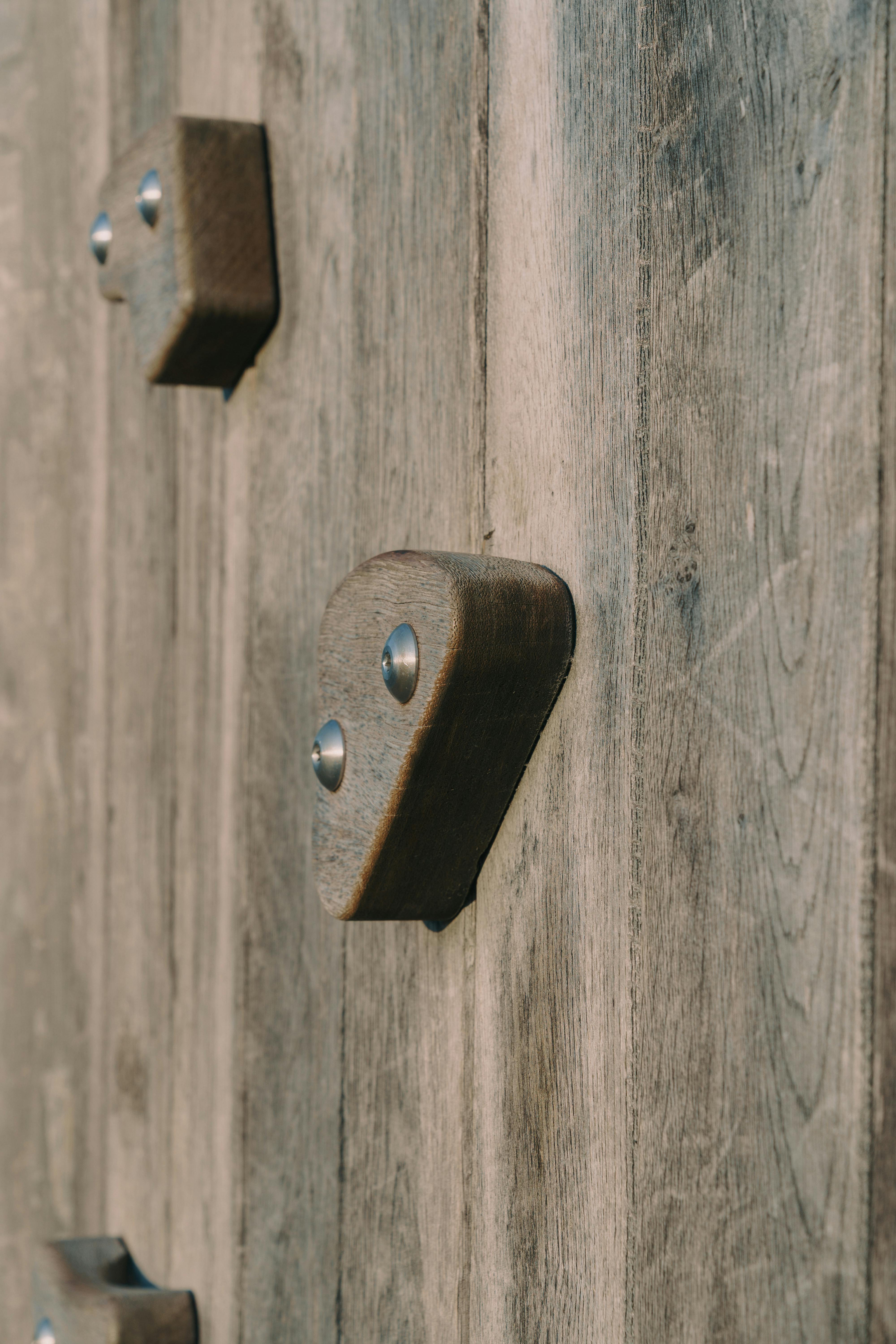 Free Detailed view of wooden rock climbing wall grips attached to a textured surface. Stock Photo