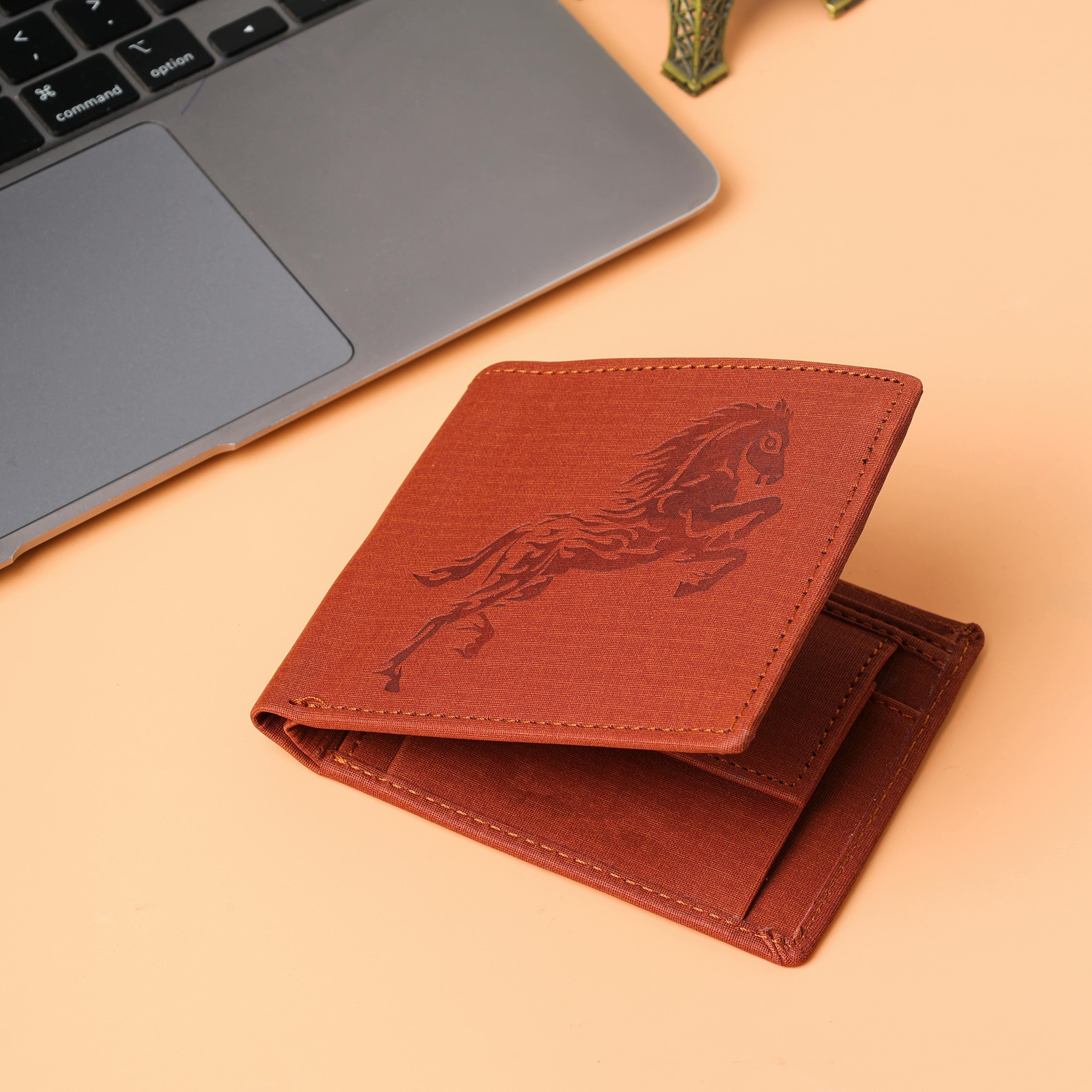 Elegant brown leather wallet with horse design pictured on a beige desk next to a laptop, ideal for lifestyle imagery.