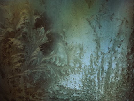 Close-up of delicate frost patterns on a window creating an abstract and ethereal feel.