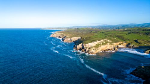 Free Stunning aerial view of the rugged coastline in Asturias, Spain during a bright summer day. Stock Photo