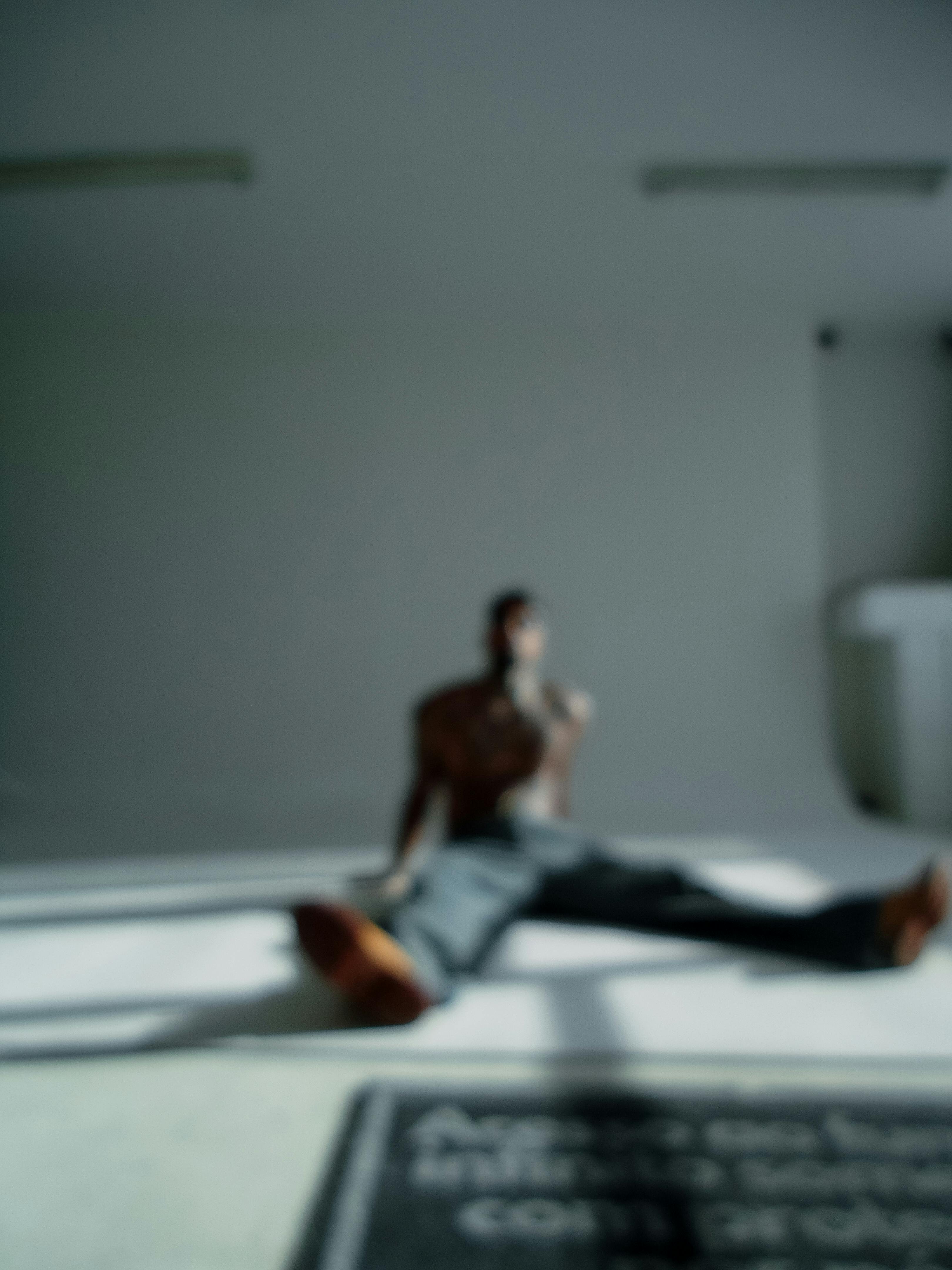 Free Abstract blurry image of a person in a minimalist room, creating an artistic impression. Stock Photo