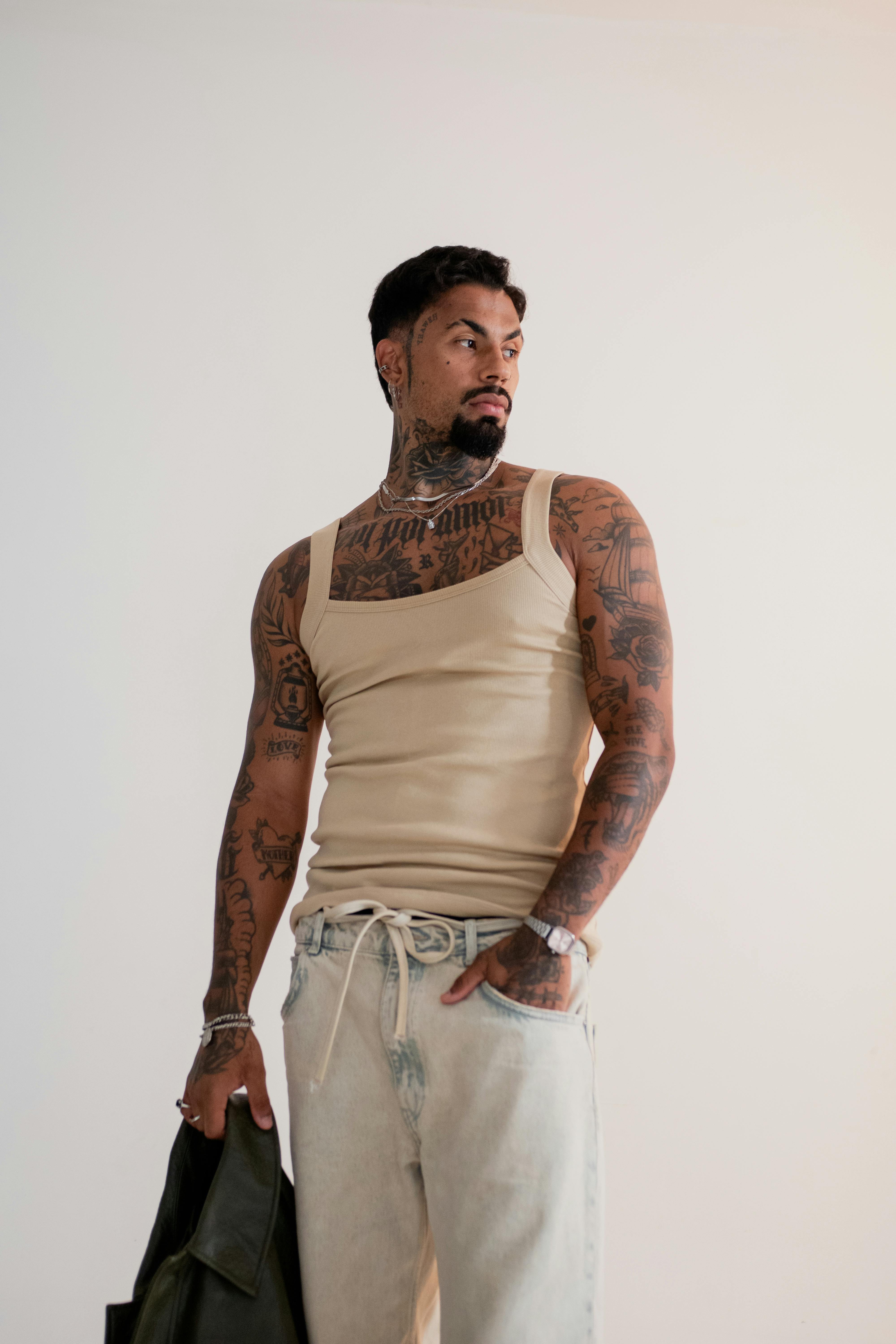 Free Stylish tattooed man wearing casual fashion with a confident pose. Stock Photo
