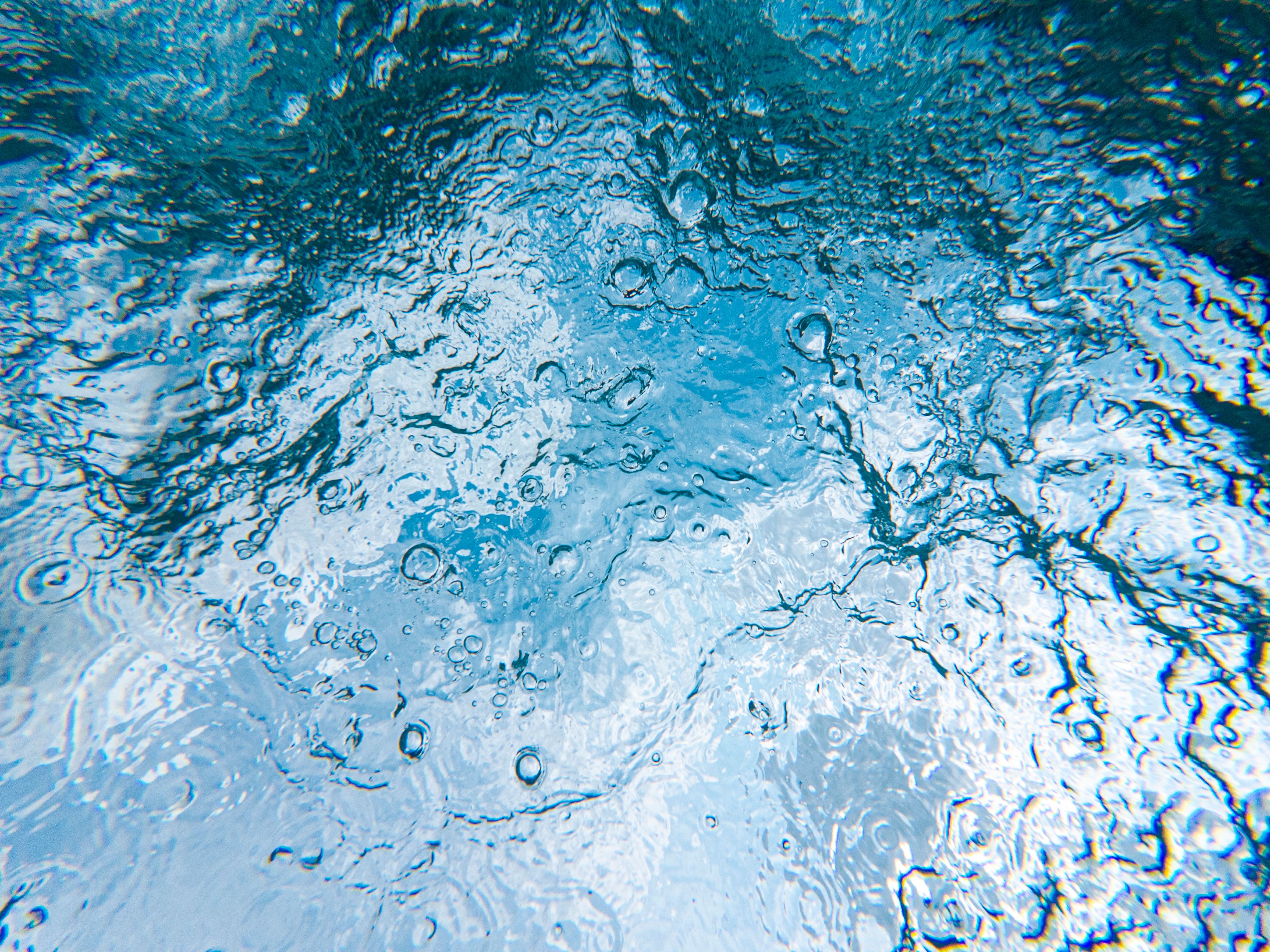 How are electrolyzer costs and efficiency improving with new materials?