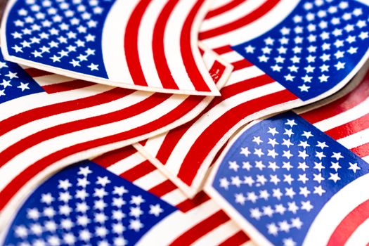 Bright close-up of overlapping American flag stickers, symbolizing patriotism and national pride.
