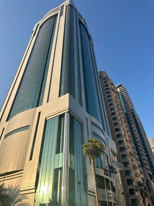 Free Tall skyscraper in Dubai with blue sky background, captured at sunset in downtown area. Stock Photo