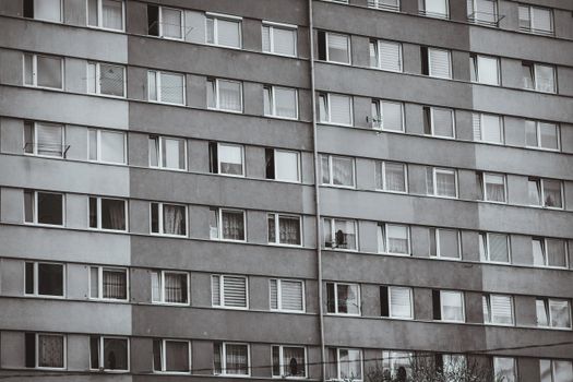 A detailed view of a high-rise building facade with repetitive windows, showcasing urban residential architecture.