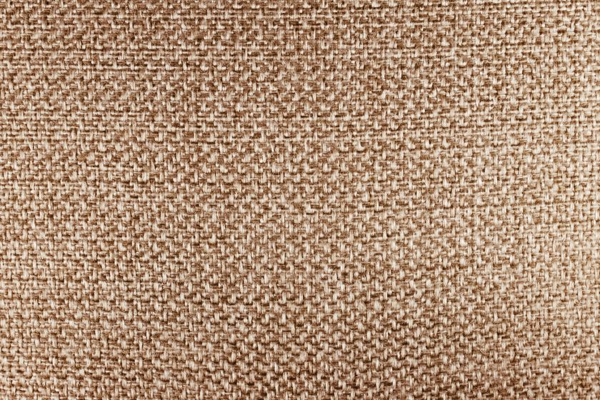 Macro close-up of a beige plain-weave cloth, warp and weft crossing over and under