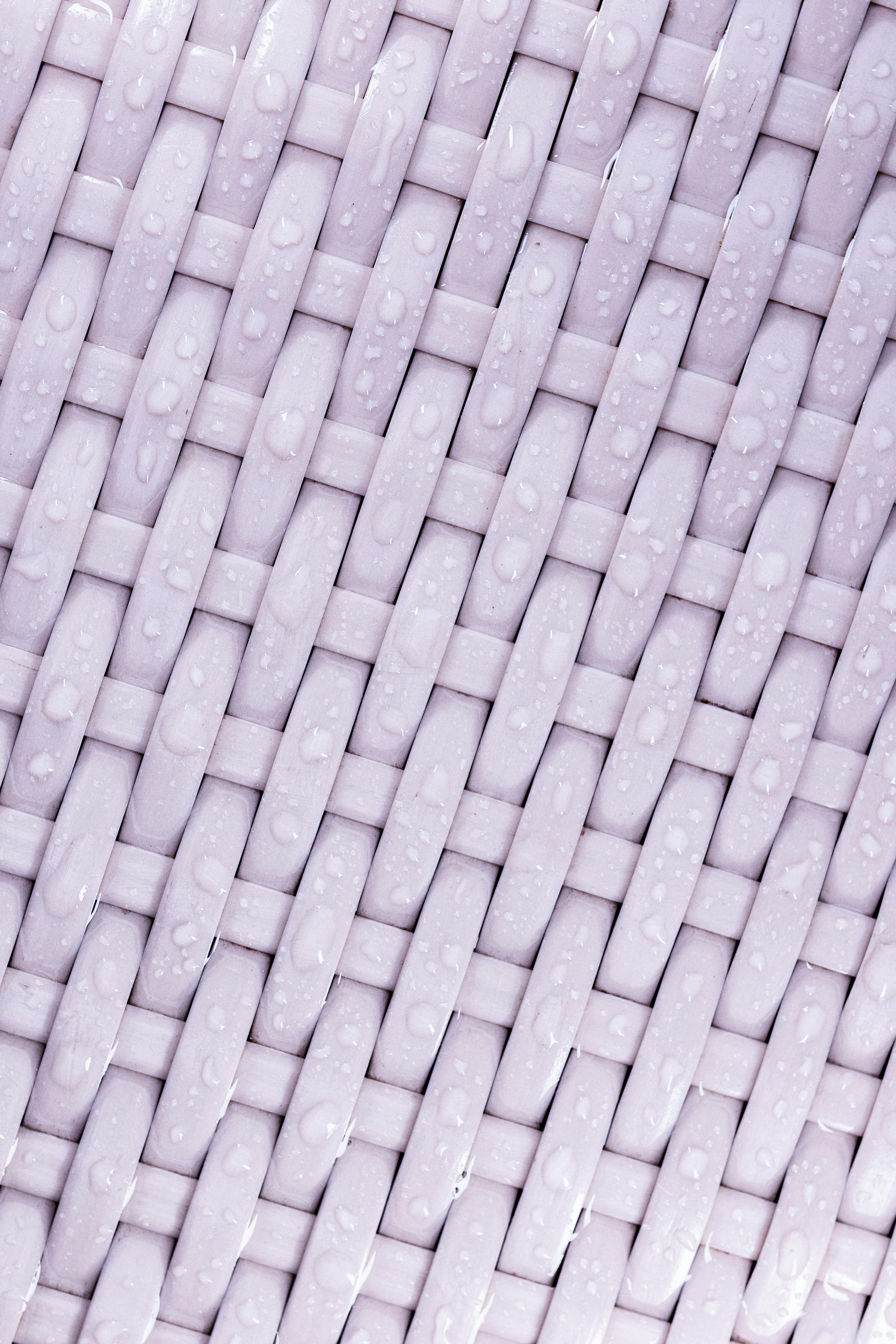 Free Detailed close-up of a wet woven wicker pattern with raindrops. Stock Photo