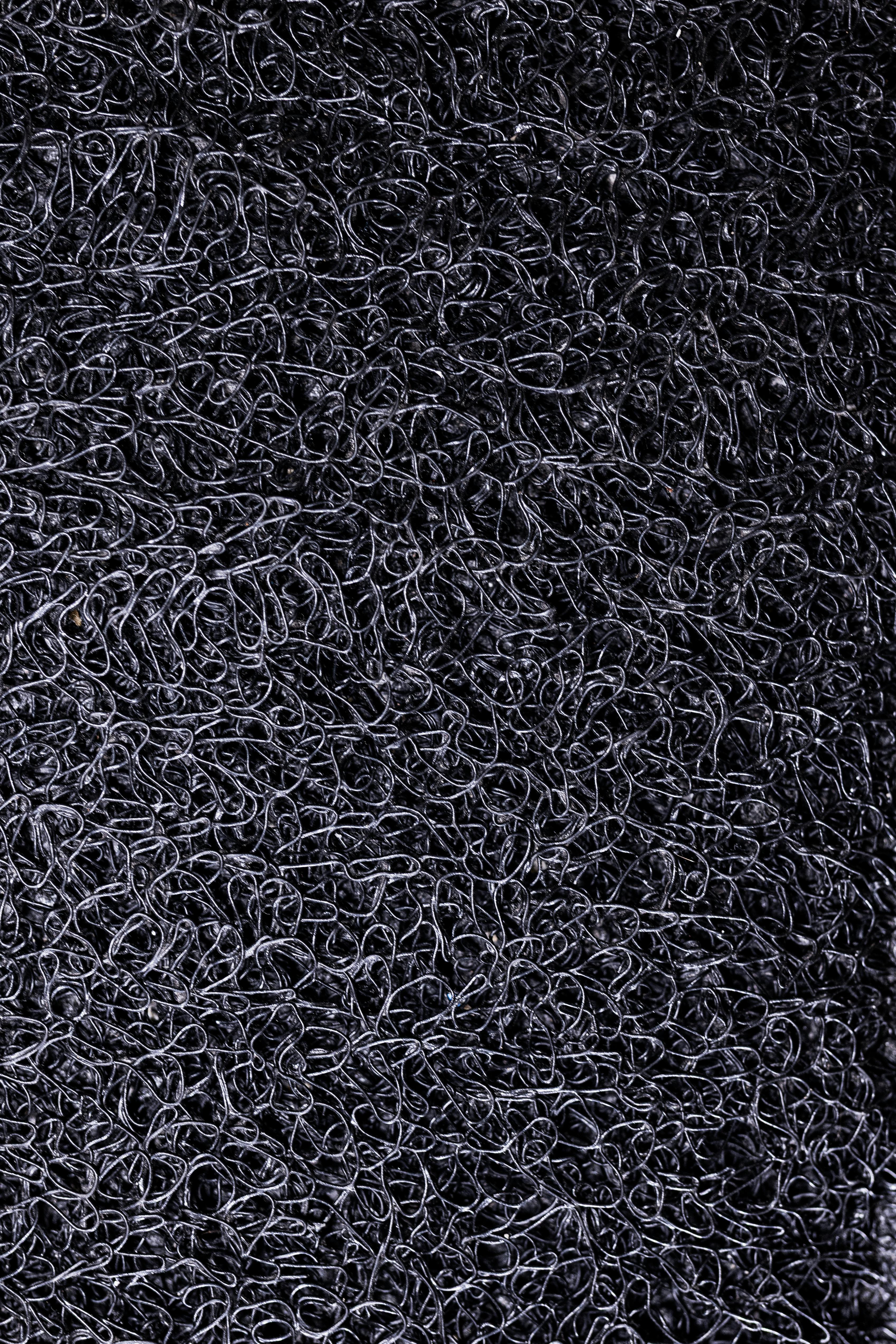 De franc Disseny abstracte intricat amb una superfície texturitzada negra amb patrons de bucle, adequat per a fons. Foto d'estoc