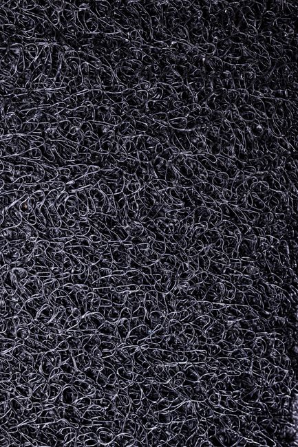 Fotomural Diseño abstracto intrincado con una superficie texturizada negra y patrones de bucles, adecuado para fondos.