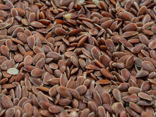 Free Macro shot of brown flax seeds highlighting their texture and natural health benefits. Stock Photo