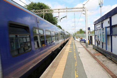 Free A fast-moving train at Holmes Chapel Station in England, capturing travel and motion. Stock Photo