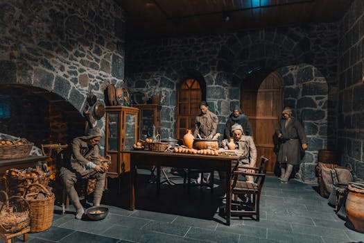 A group reenacts historical life in a stone-walled room in Kars, Türkiye.
