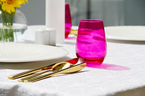 Purple Drinking Glass on White Table Cloth