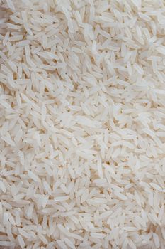A detailed close-up view of uncooked white rice grains, showing texture and detail.