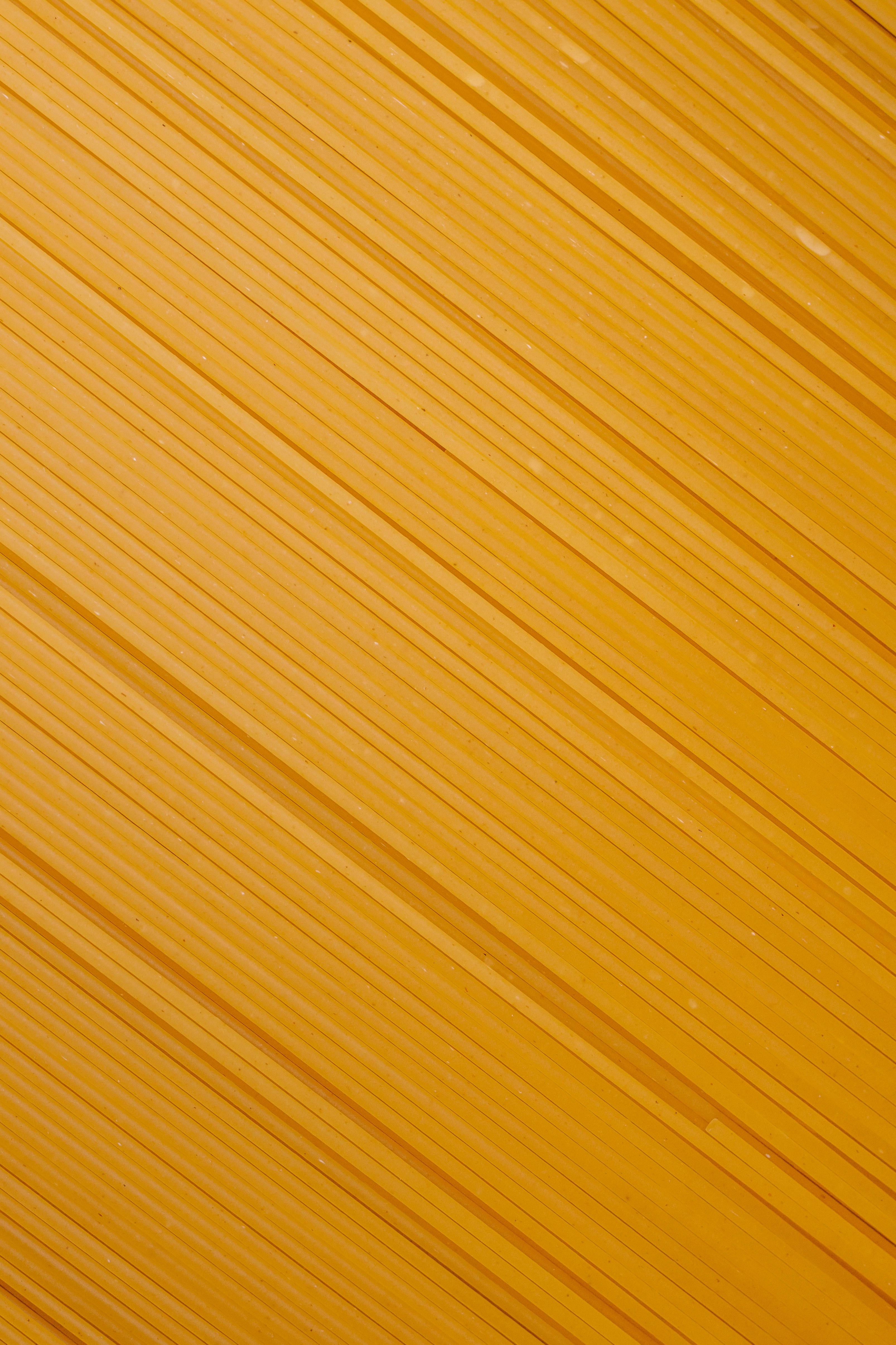 Free Detailed close-up shot of uncooked spaghetti with parallel lines creating a textured pattern. Stock Photo