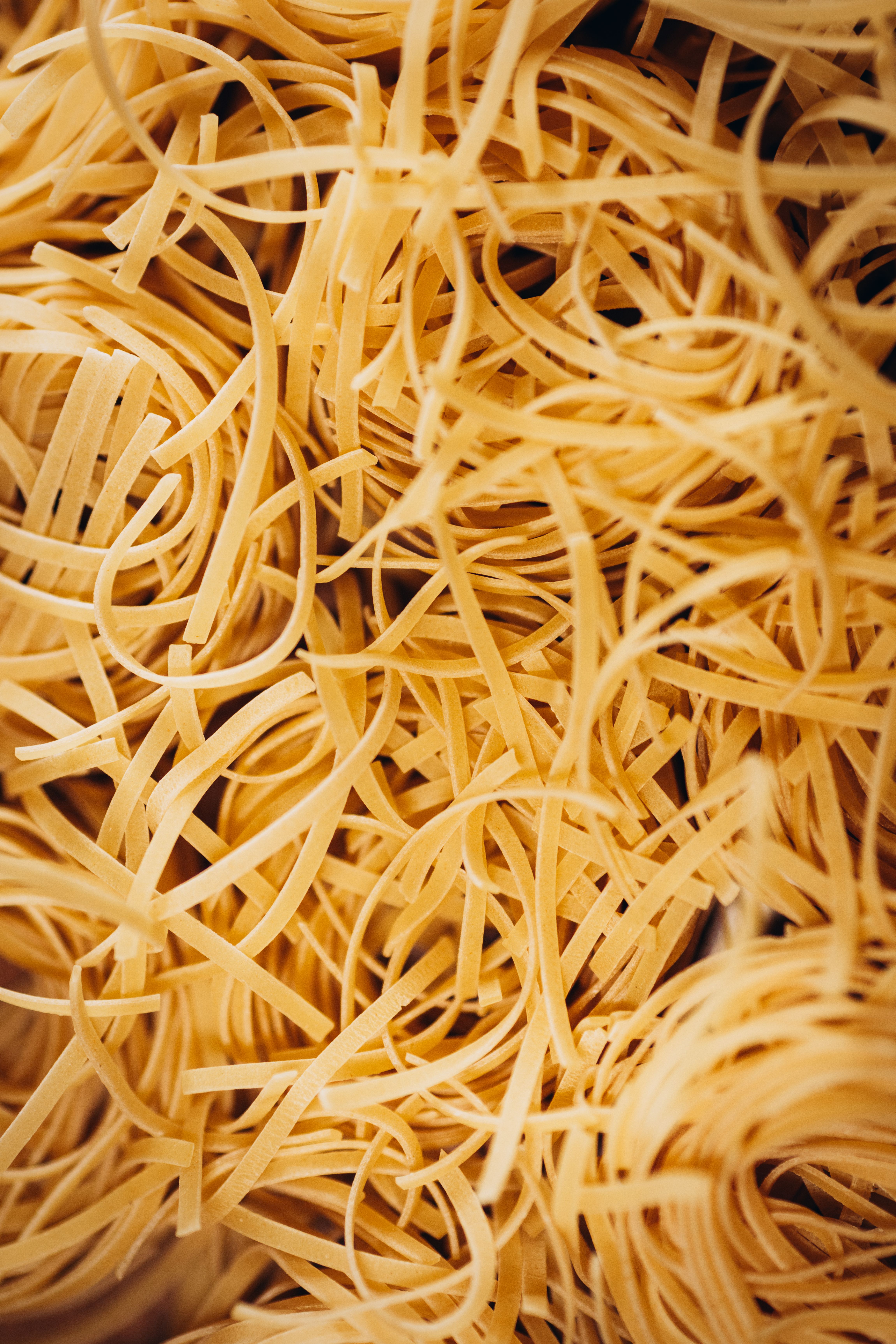 A close-up image showcasing the textured intricacies of raw noodles.