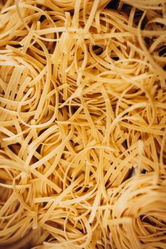 A close-up image showcasing the textured intricacies of raw noodles.