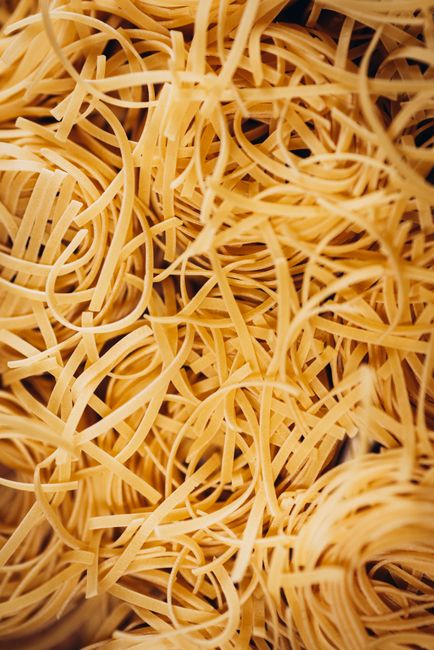 A close-up image showcasing the textured intricacies of raw noodles.