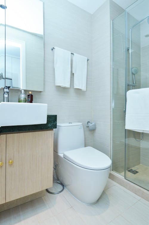 White Ceramic Sink Beside White Ceramic Toilet Bowl