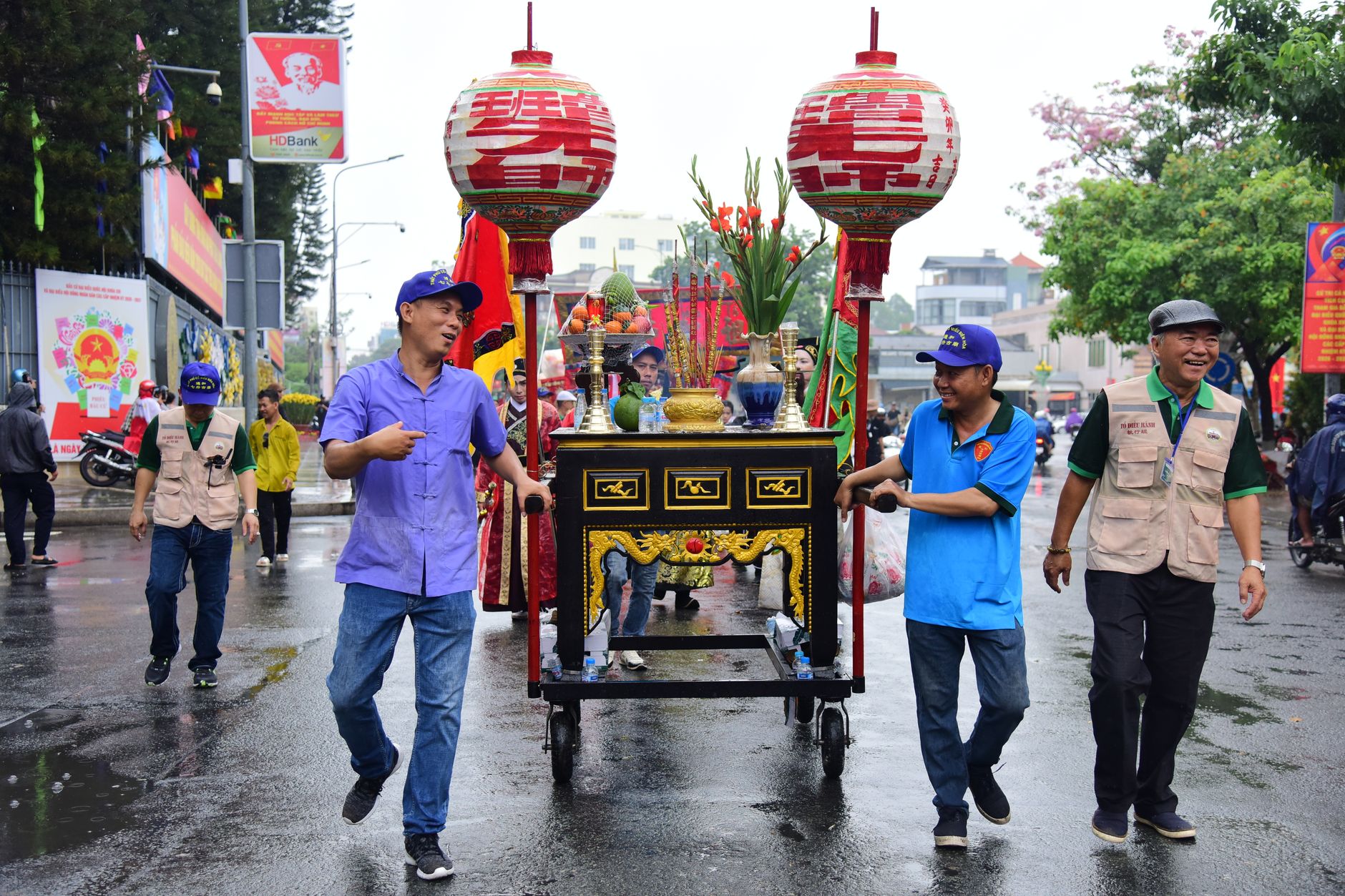 Colorful street parade with Asian cultural decorations and joyful participants.