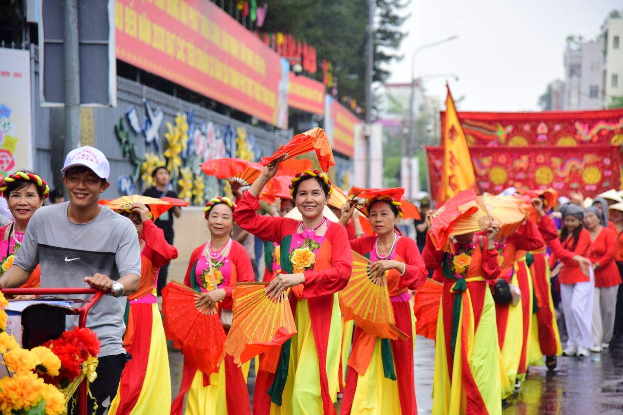 vibrant outdoor parade featuring people in traditional vietnamese atti