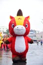 Parade featuring giant cartoon mascot outdoors