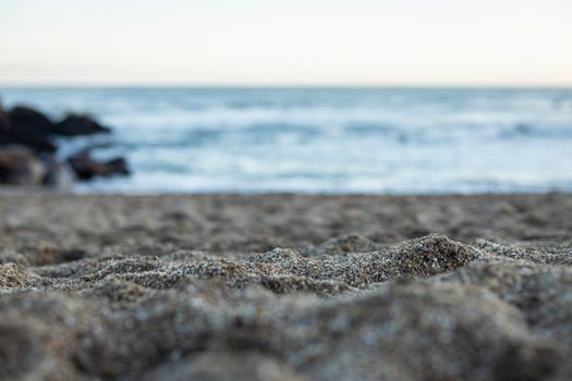 Close-up of sandy beach in Miramar, Argentina with ocean waves in the background.