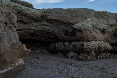 Free Natural rocky formation and cave at Miramar, Buenos Aires, showcasing rugged textures and coastal scenery. Stock Photo