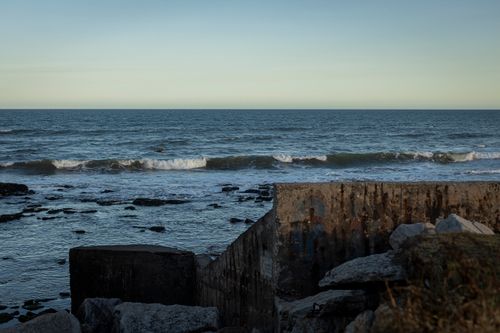Free Rustic seaside view with waves crashing on rocks at Miramar during daylight. Stock Photo
