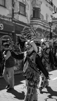 Black and white photo of dancers performing at carnival in Pachuca, Hidalgo, Mexico.