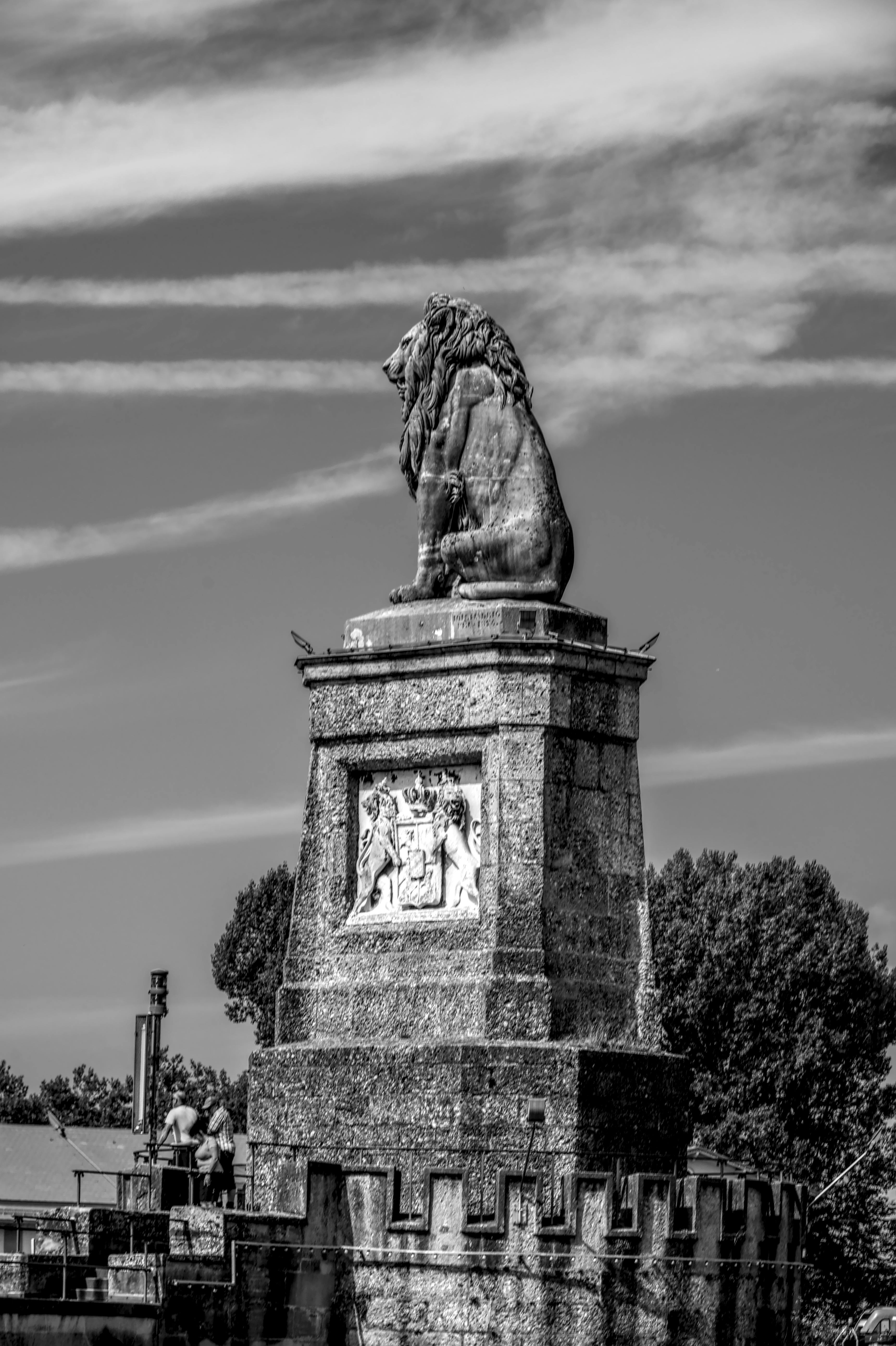 Gratis Svart-hvitt-bilde av den ikoniske løvestatuen ved Lindau havn mot en overskyet himmel. Arkivbilde