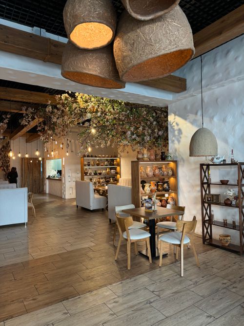 Free Charming cafe in Odesa, Ukraine featuring rustic wooden decor and floral arrangements for a cozy ambiance. Stock Photo