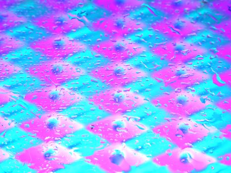 Colorful abstract surface with water droplets creating a neon visual effect.