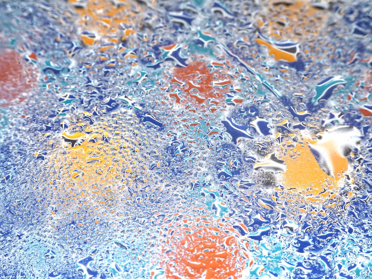 a vibrant abstract image of water droplets on a multicolored surface c