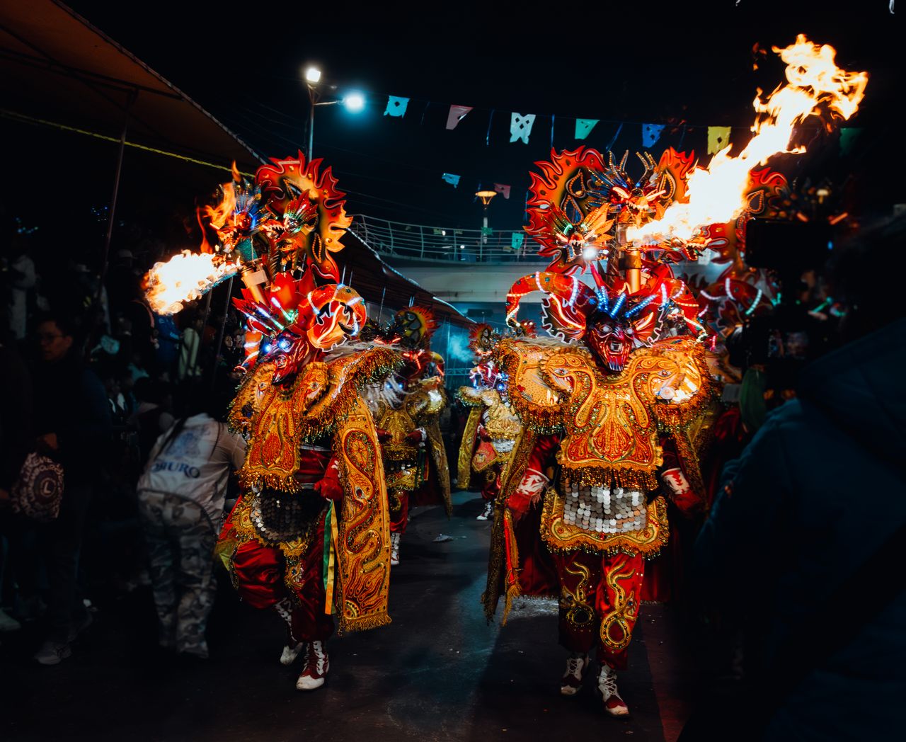 colorful performers in fiery costumes during bolivia s diablada festiv