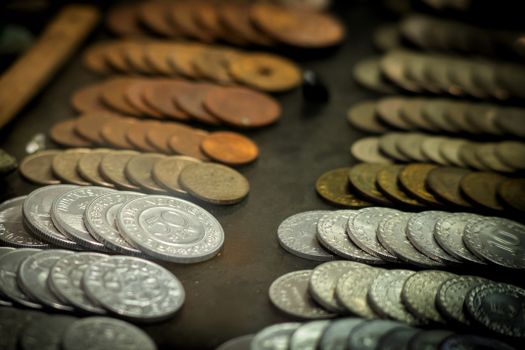 A close-up shot of vintage Indonesian coins displayed on a surface, highlighting various denominations and materials.