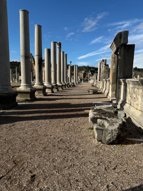 Free Explore the ancient Roman columns of Perge ruins in Türkiye under a clear blue sky. Stock Photo