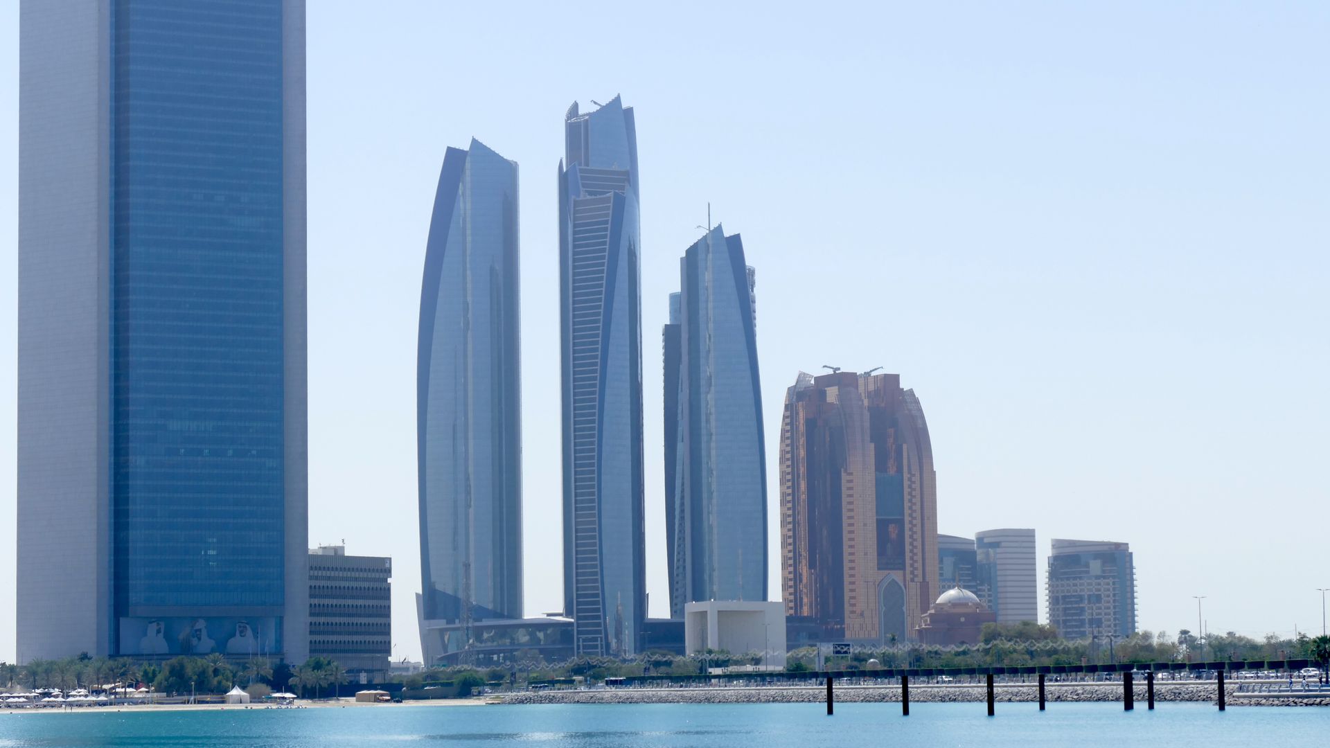 Abu Dhabi skyline with modern skyscrapers reflected over calm water
